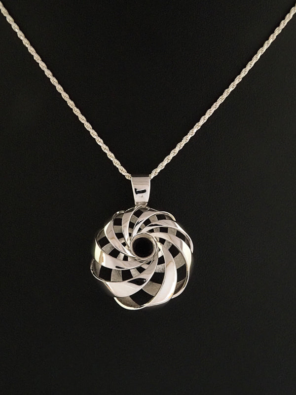 A 25mm rhodium-plated brass cyclide pendant on a silver French rope chain.