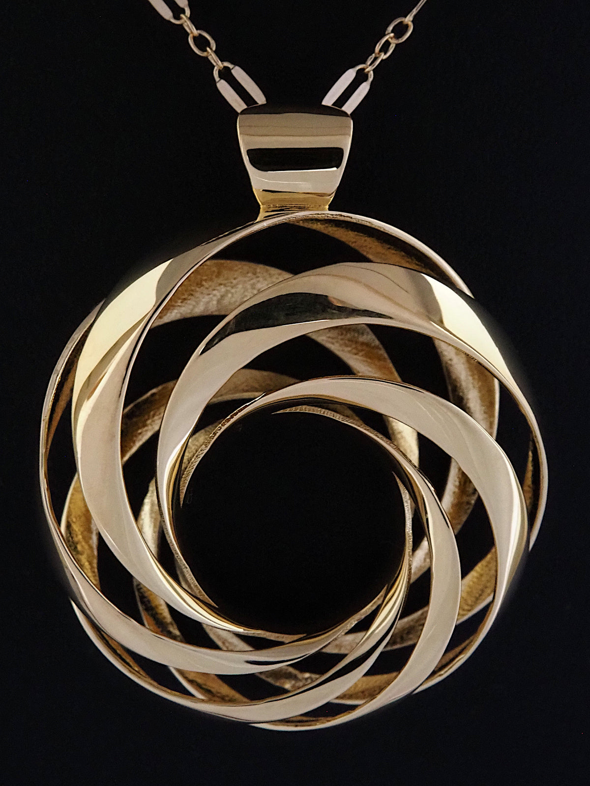 Close-up of a 35mm gold-plated brass cyclide pendant on a gold long-and-short loop chain.