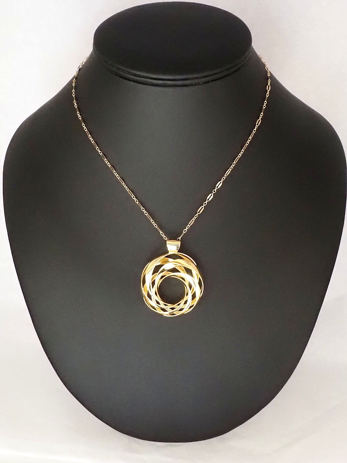 A 35mm gold-plated brass cyclide pendant with a gold long-and-short loop chain on a necklace display.